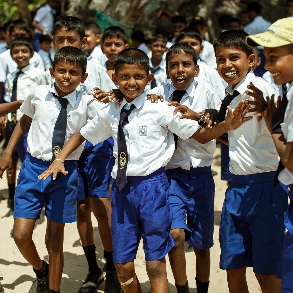 School children dressed in uniform have fun and play in the schoolyard. Wadduwa, Sri-Lanka.